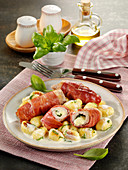 Saltimbocca rolls filled with basil and cheese and served with gnocchi