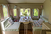 Bunting and set table in vintage-style caravan