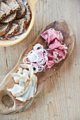 Smoked ham and lardo (fatty, white bacon) on a bread board