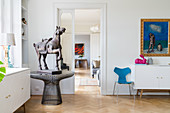 Horse sculpture on round metal table in classic living room