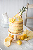 A naked cake with pineapple, mango and lemons