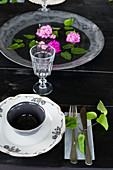 Floating flowers in dish on table set in vintage style