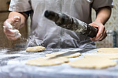 Rolling out cookie dough on a floured surface