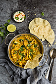 Vegan Cauliflower Korma curry in a Balti dish served with popadoms