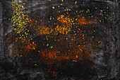 Natural aromatic spices powders spilled on dark slate surface
