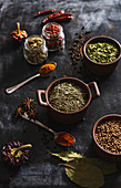 Different kinds of natural aromatic spices placed on slate surface