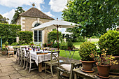 Set table on terrace in classic garden on stone house