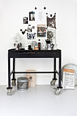 Gallery of pictures stuck on wall with washi tape above console table used as coffee station