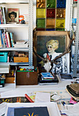 Antlers, paintings and knick-knacks between two sets of shelves