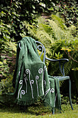 Green blanket hand-decorated with sequinned fern motifs