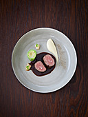 Saddle of venison with pointed cabbage roulade, bacon pears and Jerusalem artichokes