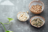 Seed mix, chickpeas and cashews in hand made clay bowls