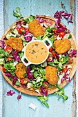 Chickpea patties with pepper sauce and salad