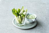 Green vegetables sticks with a dip