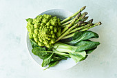 Fresh green vegetables: romanesco, spinach, asparagus and bok choy