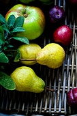 Fruit in a wicker basket with herbs