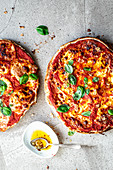 Quick flatbread pizzas with tomato sauce and basil