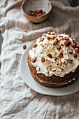 Carrot cake with cream frosting and hazelnuts