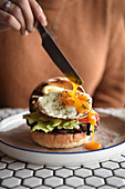 Runny egg on breakfast burger