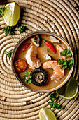Traditional spicy Thai soup tom yum kung with shiitake mushrooms and prawns