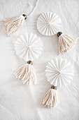 White, handmade tassels and paper rosettes