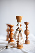 Handmade tassels on turned wooden candlesticks