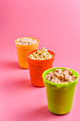 Various breakfast cereals in plastic cups
