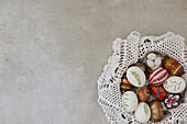 Colorful Easter eggs in a basket with lace doilies