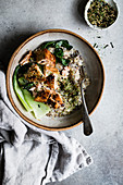 A healthy multigrain porridge with a savoury topping of miso roasted salmon and bok choy