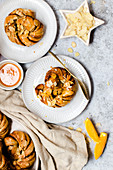 Yeast knots with almonds and orange icing