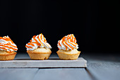 Mini muffins with whipped cream and apricot jelly
