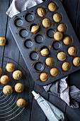 Mini muffins in a baking pan on a gray wooden table