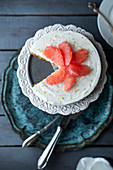 No bake cheesecake with pink grapefruit on a cake stand