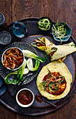 Asian wraps with duck meat, vegetables and spicy sauce
