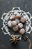 Gluten-free hazelnut biscuits with icing sugar on a doily