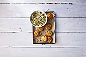 Baked falafel and cauliflower tabbouleh with green tahini sauce and charred spring onions
