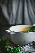 Bowl with tasty chickpea curry and herbs