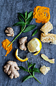 Lemon, ginger, turmeric powder, honeycomb and mint on a blue surface