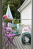 View onto balcony with colourful furniture and summery decorations