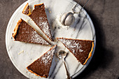 Chocolate tart with grated coconut, sliced