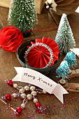 Christmas greeting on small banner, miniature Christmas trees and decorations