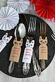 New Year's greetings and names on cat-shaped paper tags