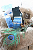 Peacock feather and wrapped gifts in jute sack