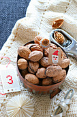 Gifts for St. Nicholas' day: walnuts in copper cake tin on hand-crocheted blanket