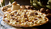 Sweet pizza with walnuts, goat cheese and honey