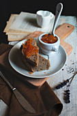 A slices of handmade bread with homemade kumquat marmelade on the wood table