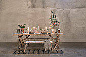 Festively decorated, rustic wooden table with frame made from branches