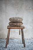 Suede cushions on wooden stool