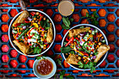 Chaat salad (spicy chickpea salad, India) with samosas and peanuts