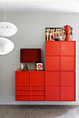 Red wall-mounted cabinets made from various modules and red accessoried